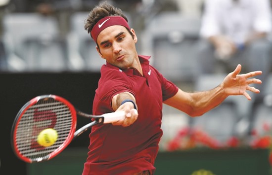 Switzerlandu2019s Roger Federer returns the ball to Germanyu2019s Alexander Zverev en route to a straight sets win to make the third round of the Rome ATP-WTA tournament yesterday. Federer won the 89-minute clash 6-3, 7-5. (AFP)