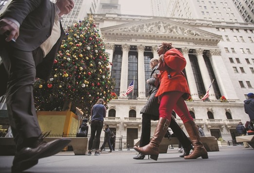 Pedestrians walk past the New York Stock Exchange. The last time corporate leverage weighed as heavily as it does now on US stock selection, equities were in the grips of a decline that wiped out $1tn in market value.