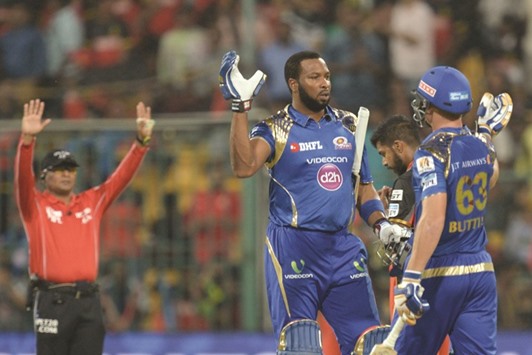 Mumbai Indians batsmen Keiron Pollard (left) and Jos Buttler celebrate their victory over Royal Challengers Bangalore during the Indian Premier League match against Royal Challengers Bangalore in Bangalore yesterday. (AFP)