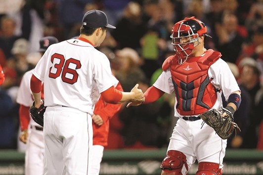 Boston Red Sox pitcher Junichi Tazawa (No 36) and catcher Christian Vazquez celebrate defeating the New York Yankees 8-0 at Fenway Park. PICTURE: USA TODAY Sports