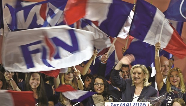 Marine Le Pen waves after her speech during a party meeting in Paris yesterday.