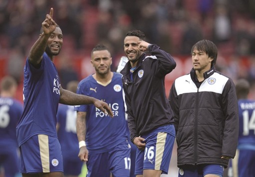 Leicester Cityu2019s defender Wes Morgan (L) and midfielder Riyad Mahrez (C) gesture after the English Premier League football match between Manchester United and Leicester City at Old Trafford in Manchester, north west England yesterday.