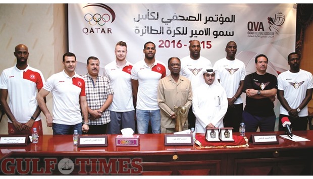 Qatar Volleyball Association technical director Hussein Imam Ali, Al Arabi coach Maaouia Lajnef, El Jaish coach Zohair Belhadj, players and officials pose with the Emir Cup trophy after a  press conference ahead of their Emir Cup volleyball final yesterday. PICTURES: Jayaram