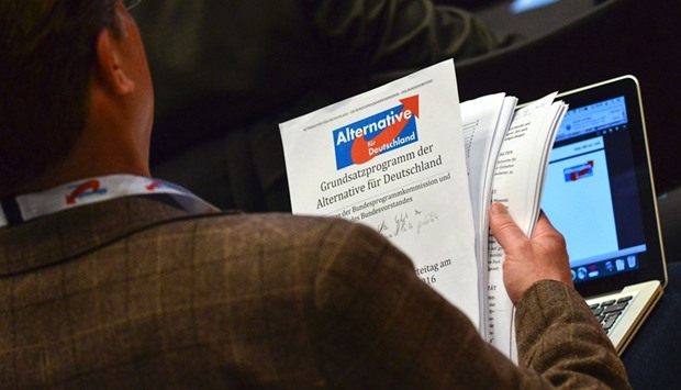 An AfD delegate holds a draft of the party programme during the party congress in Stuttgart yesterday.