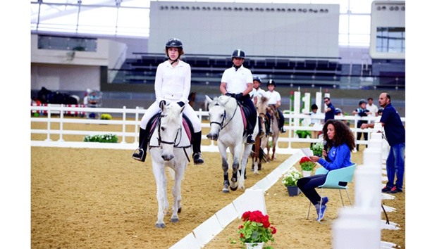 Junior riders of Al Shaqabu2019s Equine Education Department in action during the competitions at the Al Shaqab indoor arena.