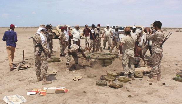 Yemeni security forces inspecting unexploded ordnance confiscated from Al Qaeda militants in the Lahj province, as they prepare to neutralise mines and explosives in the desert of al-Alam, east of the southern port city of Aden, on Apil 29.