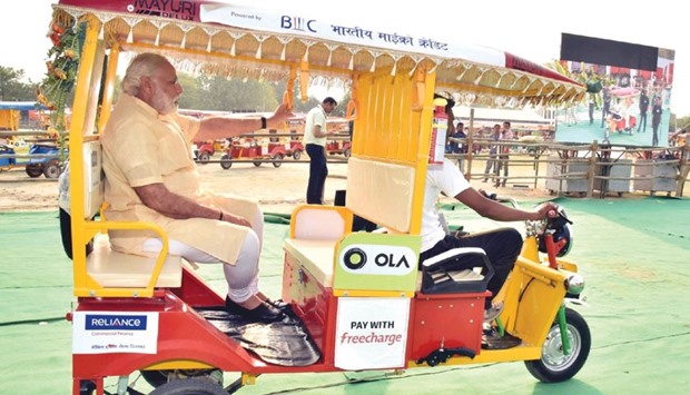 Prime Minister Narendra Modi enjoys an e-rickshaw ride in Varanasi yesterday.