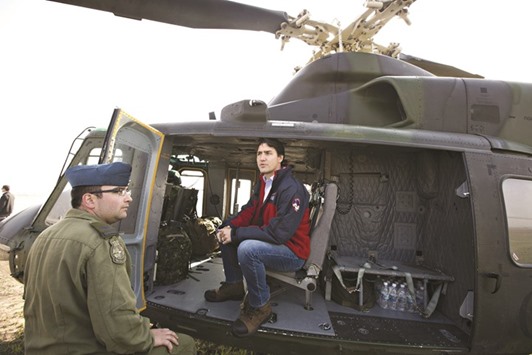 Canadian Prime Minister Justin Trudeau prepares to take a helicopter tour to inspect the damage caused by the wildfire in Fort McMurray, Alberta, Canada.