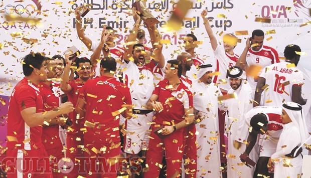 Al Arabi players and officials celebrate their win in the Emir Cup volleyball with the winnersu2019 trophy at the Ali Bin Hamad Al Attiyah Arena yesterday. PICTURES: Jayaram
