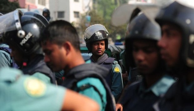 Bangladesh Police stand guard at the site of attack
