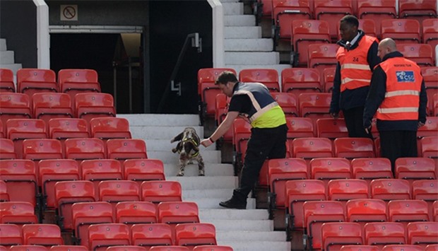 A sniffer dog searches the stands after fans evacuated Old Trafford stadium in Manchester