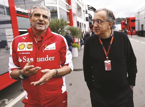 File picture of Ferrari Formula One team leader Maurizio Arrivabene (L) and Sergio Marchionne.