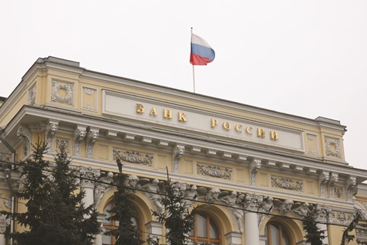 A Russian national flag flies above the headquarters of Russiau2019s central bank in Moscow. The Bank of Russia stepped forward as a seller of local-currency government bonds that triggered a spike in trading as an approaching liquidity surplus prompts policy makers to drain excess roubles.