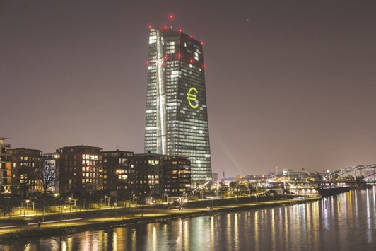 An illuminated euro currency symbol is projected on to the European Central Bank (ECB) headquarters during the Luminale light festival in Frankfurt on March 17. There has been widespread criticism in Germany of the ECBu2019s monetary policy in recent weeks, with politicians complaining that low interest rates are hitting the retirement provisions of ordinary Germans and could boost the right wing.