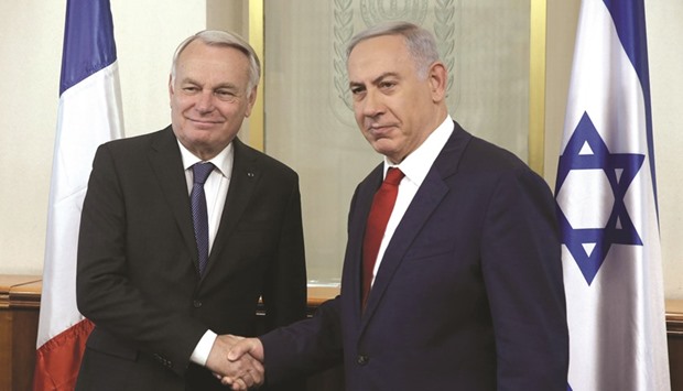 Israeli Prime Minister Benjamin Netanyahu shakes hands with French Foreign Minister Jean-Marc Ayrault (left) yesterday during a meeting in Jerusalem.