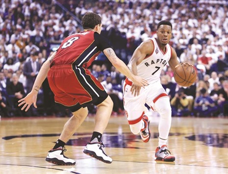 Kyle Lowry (right) of the Toronto Raptors dribbles the ball past Tyler Johnson of the Miami Heat during Game Seven of the Eastern Conference quarterfinals at the Air Canada Centre in Toronto, Canada, on Sunday. (AFP)