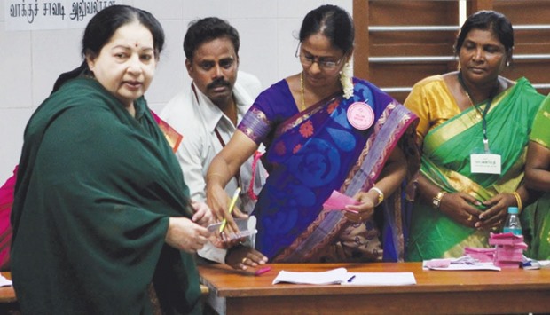Tamil Nadu Chief Minister and All India Anna Dravida Munnetra Kazhagham party leader J Jayalalithaa has her voting card checked by election officials as she arrives to cast her vote at a polling station in Chennai yesterday.