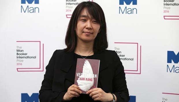 South Korean author Han Kang poses with her novel The Vegetarian, which is nominated for the Man Booker International Prize, during a media event in London.