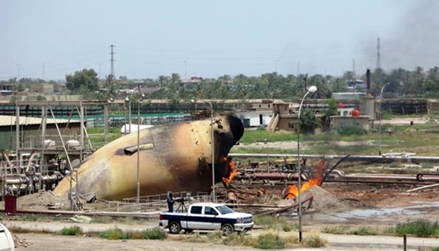 A burning tank is pictured after a suicide bomb attack on the Taji gas plant near Baghdad earlier this week.