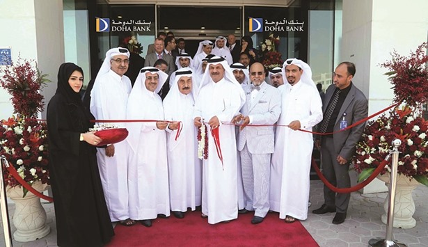 Doha Bank chairman Sheikh Fahad bin Mohamed bin Jabor al-Thani cuts the ribbon during official opening of the Al Gharafa branch.