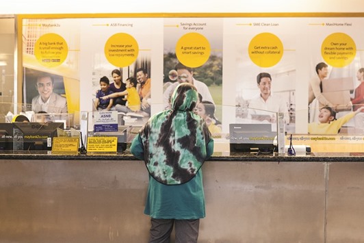 A customer stands at a service counter inside a combined Malayan Banking (Maybank) and Maybank Islamic bank branch in Kuala Lumpur. The Islamic venture capital is mostly following the Islamic concept of mudharabah, a form of partnership where a bank or a capital provider, in this case the Islamic venture capital fund, enters an agreement with an entrepreneur to kick off business activity.