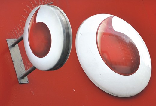 Vodafone branding is seen outside a retail store in London. Shares in the worldu2019s second-largest mobile phone operator rose 1.5% yesterday after it said earnings growth would accelerate this year.