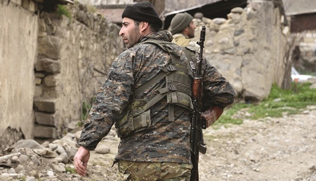 This file photo taken on April 6 shows a soldies of the Nagorny Karabakh defence army patroling on a road in the village of Talish, some 80km north of Karabakhu2019s capital Stepanakert.