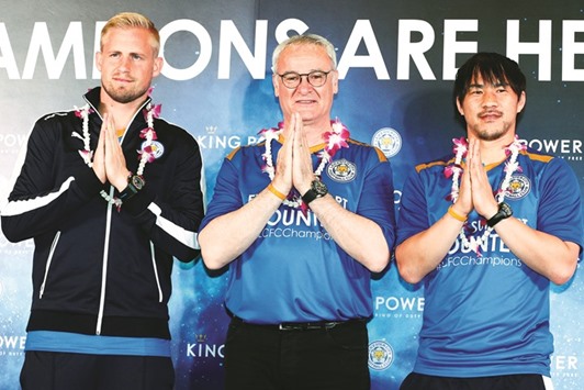Leicester Cityu2019s manager Claudio Ranieri (C) and players Kasper Schmeichel (L) and Shinji Okazaki (R) at the Suvarnabhumi International Airport in Bangkok yesterday. (Reuters)