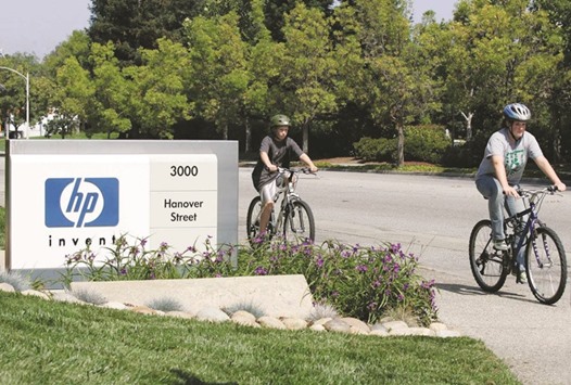 Children ride their bikes past a Hewlett Packard sign at HPu2019s Palo Alto headquarters. Putting money into startups is a way for the company to contend with new technologies from rivals like Amazon.com and Google. Itu2019s also an effort to end a checkered spending pattern on acquisitions in the past decade.
