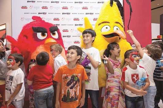 THRILLED: Children interacting with the Angry Birds Movie characters u2014 Chuck and Red u2014 before the screening.