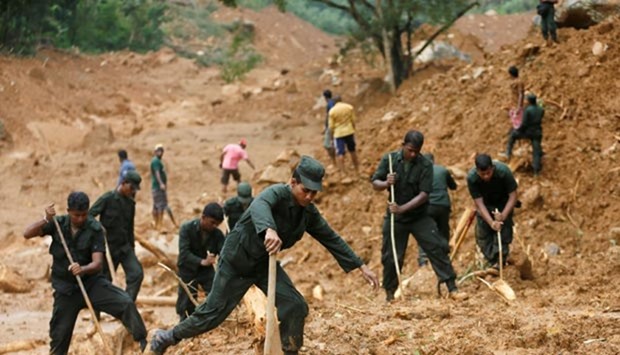 Members of a Sri Lankan military rescue team work at the site of a landslide at Elangipitiya village in Aranayaka on Thursday.