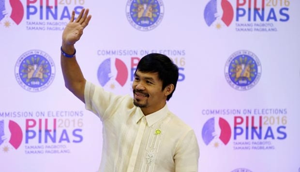Philippine boxing star Manny Pacquiao waves to supporters after he was declared a senator by the elections commission, in Manila on Thursday.
