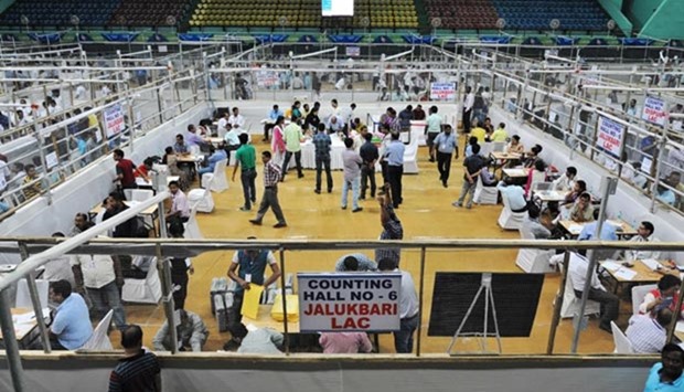 Indian election officials count votes following the state assembly elections at a counting centre in Guwahati on Thursday.