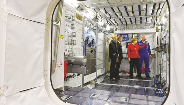 Merkel with Gerst, German Aerospace Centre (DLR) executive board chairman Pascale Ehrenfreund, DLR chairman Johann-Dietrich Woerner (second left) in the Columbus Module during her visit to the European Astronaut Centre in Cologne.