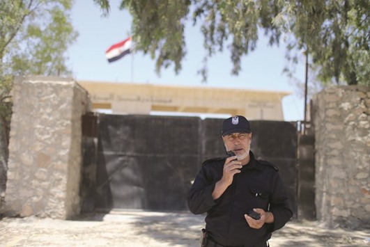 A member of the Palestinian security forces loyal to Hamas speaks on a walkie-talkie at the Rafah border crossing between Egypt and southern Gaza Strip.