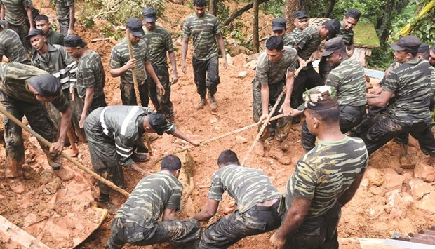 Military personnel taking part in relief and rescue efforts following a landslide in the village of Bulathkohupitiya, a mountainous area northeast of Colombo, yesterday.