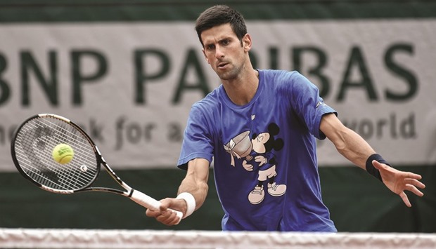 Novak Djokovic of Serbia returns the ball during a training session ahead of the French Open, yesterday at Roland Garros stadium in Paris. (AFP)