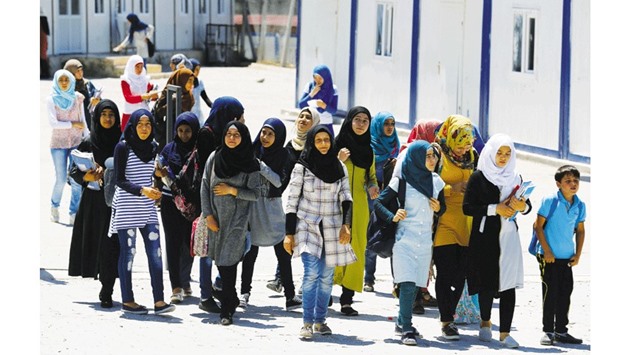 Syrian refugee school children walk to their classes at a refugee camp in Osmaniye, Turkey.