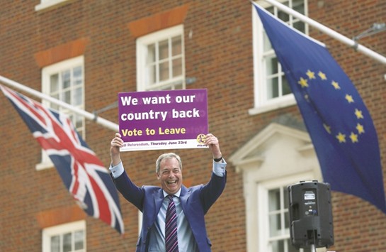 United Kingdom Independence Party leader Nigel Farage holds a placard as he launches his partyu2019s EU referendum tour bus in London yesterday.
