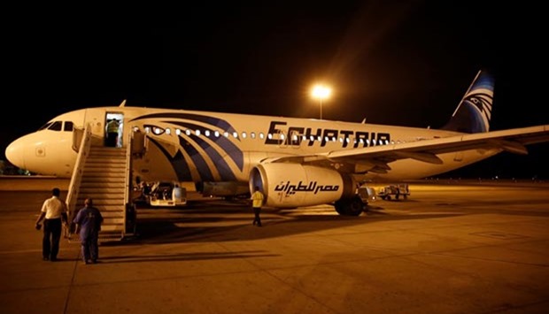 Airport security staff check an EgyptAir plane at Luxor International Airport after it arrived from Cairo on Thursday night.