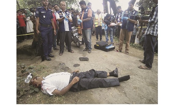 Investigators looking over the body of 58-year-old homeopathic doctor Sanaur Rahman after unknown assailants hacked him to death in Kushtia yesterday.
