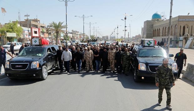 Mourners attend the funeral of anti-government protesters in Baghdad