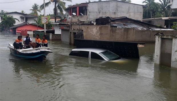 Sri Lankan navy personnel evacuate residents following flooding