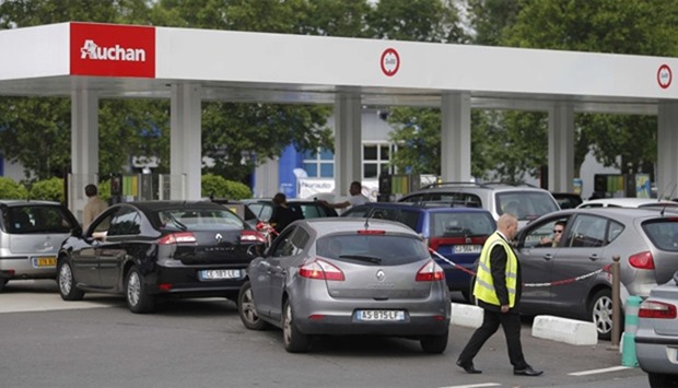 Cars wait to get gas at a petrol station at a supermarket in Saint-Sebastien-sur-Loire near Nantes, 