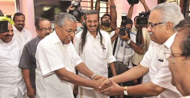 Communist Party of India secretary Kanam Rajendran receives chief minister-designate Pinarayi Vijayan (left) at the party headquarters in Thiruvananthapuram yesterday.