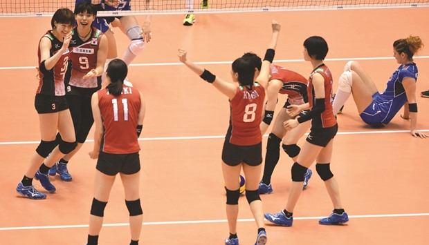 Japanese players celebrate after winning a point against Italy during the womenu2019s volleyball qualification for the Rio de Janeiro Olympics in Tokyo yesterday. (AFP)