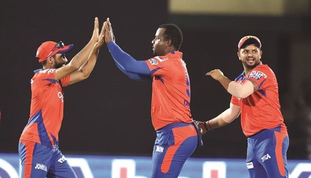 Gujarat Lionsu2019 Dwayne Smith (centre) celebrates with teammates Suresh Raina (right) and Ravindra Jadeja after getting a wicket against Mumbai Indians in Kanpur. (AFP)
