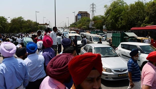 Indian taxi drivers and owners shout slogans as they block a road during a protest in New Delhi on Monday.