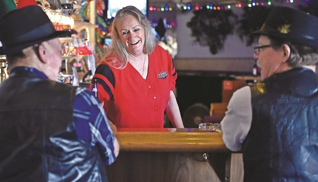 Bartender Debbie Aguilera serves customers inside the Cal-Nev-Ari Casino in Cal-Nev-Ari, Nevada.
