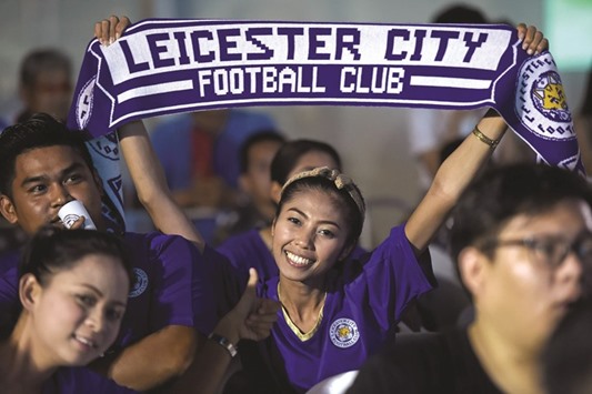 A Leicester City supporter reacts in Bangkok, as she watches a live broadcast of the English Premier League football match between Manchester United and Leicester City.